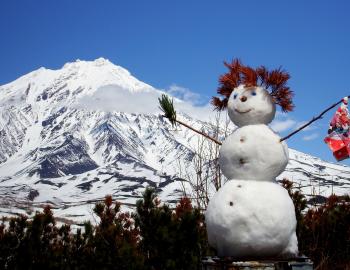 Snowman in front of the mountains
