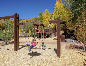 Children playing at a mountain playground