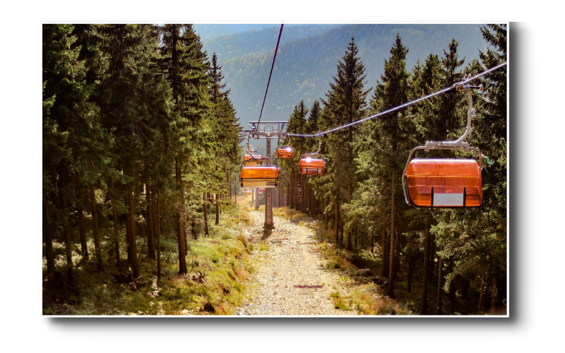 Red chair lifts over a green field